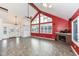 Red-walled living room with vaulted ceiling, fireplace and hardwood floors at 11736 Grazing Ln, Indianapolis, IN 46239