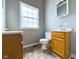 Small bathroom with toilet, vanity, and window at 31 S Superior St, Orestes, IN 46063