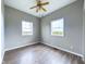 Simple bedroom with two windows, ceiling fan, and laminate flooring at 31 S Superior St, Orestes, IN 46063
