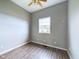 Small bedroom with one window, ceiling fan, and laminate flooring at 31 S Superior St, Orestes, IN 46063