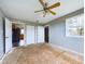 Bedroom with exposed subfloor, ceiling fan, and access to kitchen at 31 S Superior St, Orestes, IN 46063