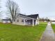 Gray siding house with a covered porch and a spacious yard at 31 S Superior St, Orestes, IN 46063