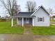 Gray siding house with a covered porch and well-maintained lawn at 31 S Superior St, Orestes, IN 46063