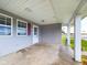 Covered front porch with concrete flooring and access to the front door at 31 S Superior St, Orestes, IN 46063