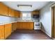 Kitchen with wood cabinets, laminate floor, and a window at 31 S Superior St, Orestes, IN 46063