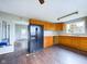 Kitchen with wood cabinets, laminate floor, and appliances at 31 S Superior St, Orestes, IN 46063
