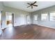Large living room featuring laminate wood floors and multiple windows at 31 S Superior St, Orestes, IN 46063