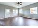 Spacious living room with dark laminate flooring and ceiling fan at 31 S Superior St, Orestes, IN 46063