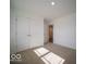 Empty bedroom with neutral carpet and double closet doors at 3194 W Keepsake Ln, Monrovia, IN 46157