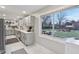 Modern kitchen with gray cabinets, quartz countertops, and a view of the backyard at 4147 Forest Manor Ave, Indianapolis, IN 46226