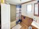 Bathroom with shower/tub combo, wooden accents, and a window at 4355 E Streacher Rd, Bloomington, IN 47408