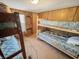 Bedroom with built-in wooden shelving and bunk beds at 4355 E Streacher Rd, Bloomington, IN 47408