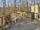 Relaxing deck with wooden railings, offering views of the surrounding woods at 4355 E Streacher Rd, Bloomington, IN 47408