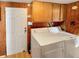 Main floor laundry room with washer, dryer, and wooden cabinets at 4355 E Streacher Rd, Bloomington, IN 47408