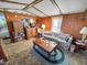 Living room with wooden cabinets, couch, and exposed beams at 4355 E Streacher Rd, Bloomington, IN 47408