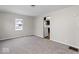 Living room with view into kitchen and carpet flooring at 50 Mckinley St, Shelbyville, IN 46176