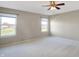 Spacious bedroom with neutral walls, carpet, ceiling fan and two windows at 7779 Blue Jay Way, Zionsville, IN 46077