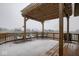 Snow covered deck with pergola, seating area, and view of a pond at 894 Scorpio Ct, Franklin, IN 46131