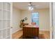 Home office with wooden desk and built-in window seat at 11211 Courtyard Way, Fishers, IN 46038