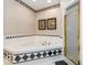 Bathroom with corner bathtub, shower, and black and white tile at 12954 Water Ridge Dr, Fishers, IN 46055