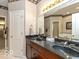 Bathroom with double sinks, dark countertops, and access to a walk-in closet at 12954 Water Ridge Dr, Fishers, IN 46055