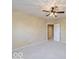 Spacious bedroom with ceiling fan and access to hallway at 12954 Water Ridge Dr, Fishers, IN 46055