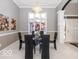 Bright dining room with glass top table and modern chandelier at 12954 Water Ridge Dr, Fishers, IN 46055