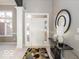 Bright entryway with tile flooring, a console table, and a large mirror at 12954 Water Ridge Dr, Fishers, IN 46055