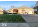 Brick house with 3-car garage, manicured lawn, and mature trees at 12954 Water Ridge Dr, Fishers, IN 46055
