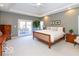 Spacious main bedroom with a king-size bed and access to a private deck at 12954 Water Ridge Dr, Fishers, IN 46055