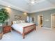 Main bedroom with king bed, tray ceiling and access to bathroom at 12954 Water Ridge Dr, Fishers, IN 46055