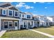 Row of townhouses with gray and white siding, stone accents, and landscaping at 19432 Northwest Dr, Westfield, IN 46074