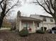 Tan colored townhouse with covered porch, stone chimney and landscaping at 3250 Valley Farms Way, Indianapolis, IN 46214