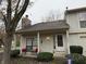 Tan colored townhouse with covered porch, stone chimney and landscaping at 3250 Valley Farms Way, Indianapolis, IN 46214