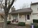Tan colored townhouse with covered porch, stone chimney and landscaping at 3250 Valley Farms Way, Indianapolis, IN 46214