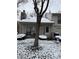 Tan colored townhouse with covered porch, stone chimney and landscaping; snow on the ground at 3250 Valley Farms Way, Indianapolis, IN 46214