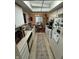 Galley kitchen with white cabinetry, tile flooring, and view to dining area at 3250 Valley Farms Way, Indianapolis, IN 46214