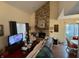 Living room with stone fireplace and view to dining area at 3250 Valley Farms Way, Indianapolis, IN 46214