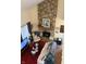 Living room with stone fireplace, comfy seating, and a red rug at 3250 Valley Farms Way, Indianapolis, IN 46214