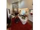 Living room with stone fireplace, red rug, and view of dining area at 3250 Valley Farms Way, Indianapolis, IN 46214