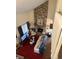 Living room with stone fireplace, comfy seating, and a red rug at 3250 Valley Farms Way, Indianapolis, IN 46214