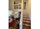 Home office space with wooden desk, bookshelves, and staircase view at 3250 Valley Farms Way, Indianapolis, IN 46214
