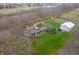 Aerial view showcasing house, detached garage, and surrounding fields at 720 E 400 N, Anderson, IN 46012