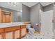 Basement bathroom with shower, toilet and wood vanity at 720 E 400 N, Anderson NE, IN 46012