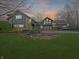 Stone house with a three-car garage and landscaped lawn, at sunset at 720 E 400 N, Anderson NE, IN 46012