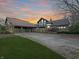 Stone house with a three-car garage and landscaped lawn, at sunset at 720 E 400 N, Anderson, IN 46012