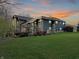 Back exterior of home showcasing stone and wood details with deck at 720 E 400 N, Anderson, IN 46012