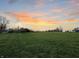 Sunset over a grassy field with distant buildings at 720 E 400 N, Anderson, IN 46012