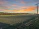 Field with powerline and sunset in background at 720 E 400 N, Anderson, IN 46012