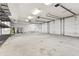 Large three-car garage with ample storage shelving and overhead door at 720 E 400 N, Anderson, IN 46012